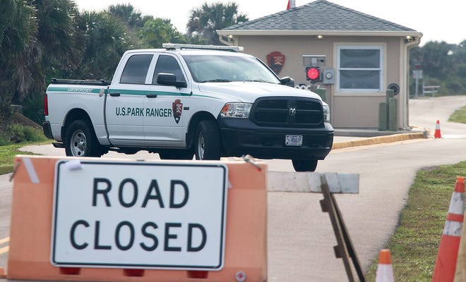 A U.S. park ranger turns his truck around at the barricade on the north end of Canaveral National Seashore on Friday. Some 1.6 million people visited the park in 2017, but no one is allowed to enter now, during the goverment shutdown.  [News-Journal/David Tucker]
