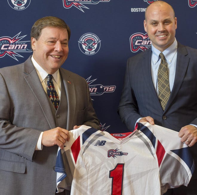 Quincy Mayor Thomas Koch and Boston Cannons team president Ian Frenette hold a team jersey together during the Dec. 4, 2018 announcement that the team would move to Veterans Memorial Field in Quincy. (Joe DiFazio/The Patriot Ledger)