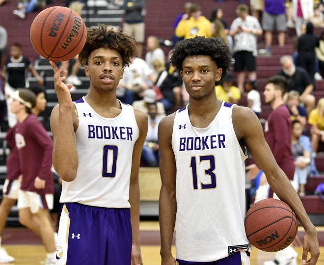 Booker High's Johnnie Williams IV, left, and Jordan Clark pose for a picture after a recent win over Saint Xavier at the Riverview High gym during the Suncoast Holiday Classic. [Herald-Tribune staff photo / Thomas Bender]