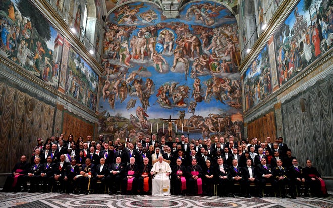 Pope Francis poses for a group photograph with members of the Diplomatic Corps accredited to the Holy See, inside the Sistine Chapel, at the Vatican, Monday, Jan. 7, 2019. (Ettore Ferrari/Pool Photo via AP)
