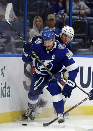 Tampa Bay Lightning center Steven Stamkos (91) beats Columbus Blue Jackets defenseman Ryan Murray (27) to the puck after a check during the second period of an NHL hockey game Tuesday, Jan. 8, 2019, in Tampa, Fla. (AP Photo/Chris O'Meara)