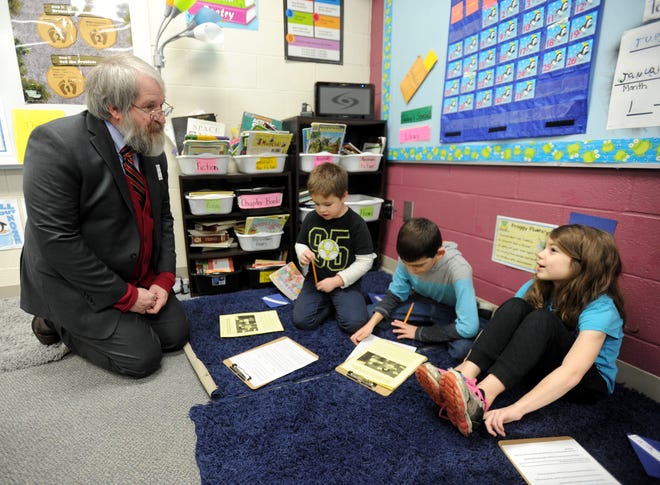 Ohio's Superintendent of Public Instruction Paolo DeMaria (left) talks with second graders (l-r) Alric Richmond, Charles Jackson and Trinity Johnson while visiting Rockhill Elementary in Alliance. (CantonRep.com / Julie Vennitti)