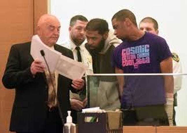 Khaylon Cruz, 24, of New Bedford, center, and Jerome Middleton, 19, of Fall River, were arraigned Tuesday in Taunton District Court in the murder of a Taunton man. [MIKE GAY/TAUNTON GAZETTE]