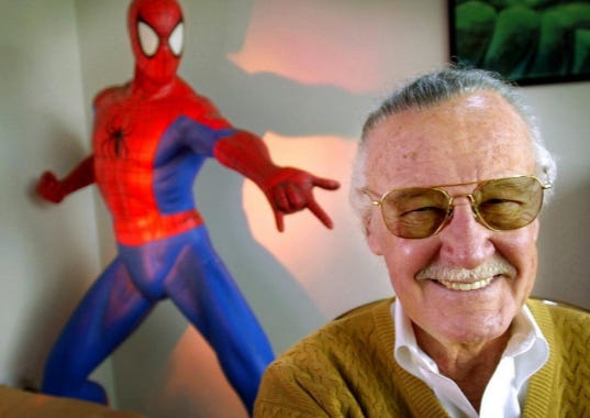 This April 16, 2002 file photo shows Stan Lee, creator of comic-book franchises such as "Spider-Man," "The Incredible Hulk" and "X-Men," posing near a Spider-Man figure in his Santa Monica, Calif., office. Friends, fans and family of Stan Lee will gather in Hollywood on Jan. 30 for a memorial honoring the life and work of the late Marvel Comics mogul.