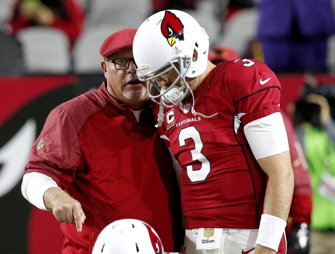 Arizona Cardinals quarterback Carson Palmer and coach Bruce Arians talk prior to a game against the Minnesota Vikings in Glendale, Ariz., in 2015. Arians has been called a quarterback whisperer for his ability to develop some of the top quarterbacks in the NFL. [AP FILE PHOTO]