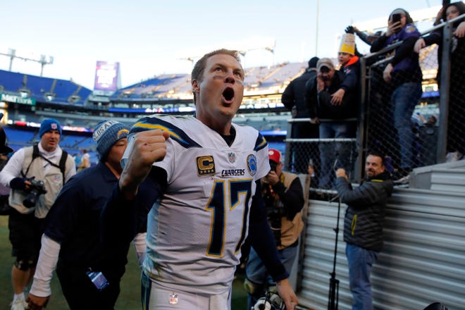 Los Angeles Chargers quarterback Philip Rivers celebates as he walks off the field after an NFL wild card playoff football game against the Baltimore Ravens, Sunday, Jan. 6, 2019, in Baltimore. Los Angeles won 23-17. (AP Photo/Carolyn Kaster)