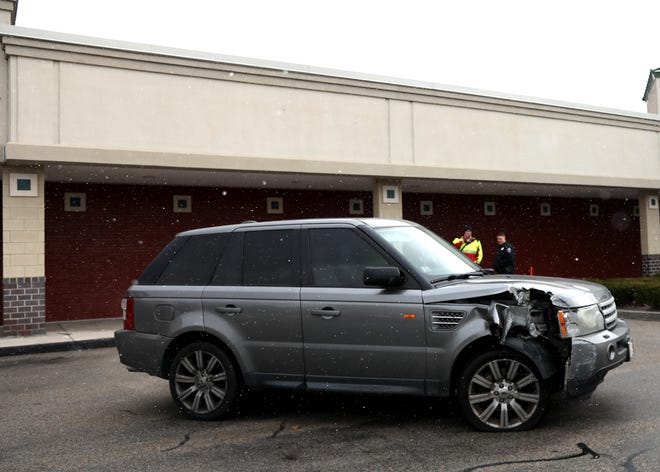 A car crashed into a pole outside T.J. Maxx in Stoughton while parking on Jan. 10, 2018. No injuries were reported and the building was structurally sound. [Alyssa Stone/The Enterprise]