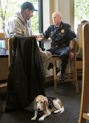 "Irish Mike" Haren, with his beagle Duke (a former candidate for the Portsmouth Police Commission), talks with Police Chief Robert Merner this past October at Popovers on the Square, as part of the National Coffee with a Cop Day. [Rich Beauchesne/Seacoastonline, file]