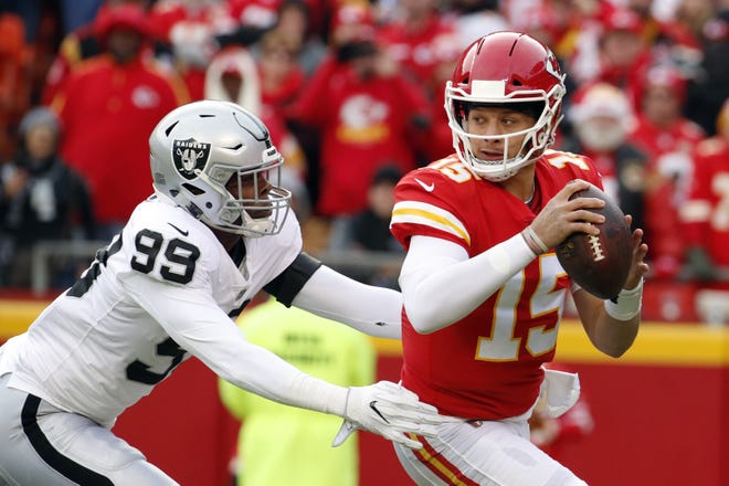 Kansas City quarterback Patrick Mahomes breaks loose from Oakland's Arden Key during a December game in Kansas City, Mo. [Charlie Riedel/Associated Press]