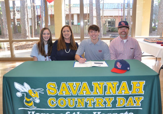 Savannah Country Day senior Win Johns (in middle with pen) signs his letter of intent alongside father Ed Johns Jr. (far right), mother Hayden (middle left) and sister Riley (far left). [SAVANNAH COUNTRY DAY]