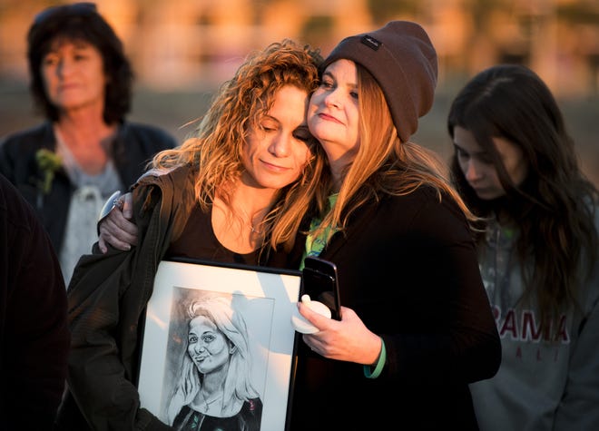 Tanya Green leans on a friend while others shared memories of her daughter, Gabbie Green, in Panama City Beach on Thursday. Gabbie Green died by suicide last year, and her family and friends gathered on the beach to remember her and help those experiencing bullying at school or thoughts of self-harm. [JOSHUA BOUCHER/THE NEWS HERALD]