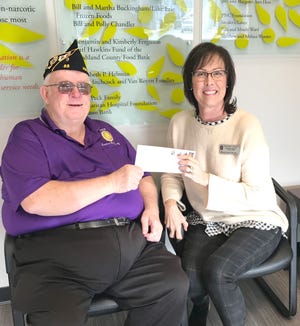 Ron Dull, commander at the American Legion Post 88, gives a donation to Rosemarie Donley, executive director of Associated Charities in Ashland. American Legion Post 88 has been donating to Associated Charities for many years now. This year’s donation was $12,000.