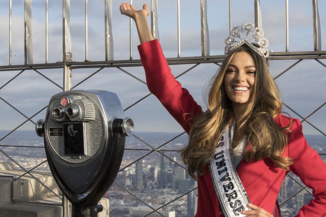 In this Tuesday, Nov. 28, 2017 file photo, Miss Universe 2017 Demi-Leigh Nel-Peters, of South Africa, poses for photographers on the 86th Floor Observation Deck of the Empire State Building in New York. Former University of Florida quarterback Tim Tebow has announced his engagement to Nel-Peters. [AP Photo/Mary Altaffer, File]