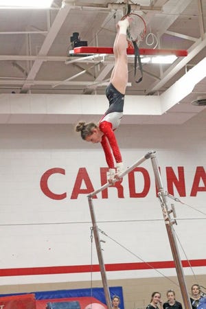 Coldwater's Layla Schoch reaches to the heavens during her bar routine versus Jackson Thursday night.