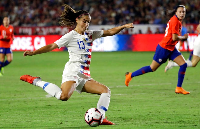 In this Aug. 31, 2018, file photo, United States' Alex Morgan shoots on goal against Chile during the first half of an international friendly soccer match, in Carson, Calif. Two goals away from reaching 100 for her career, forward Morgan is on the roster for the U.S. women's national team as it opens training camp ahead of the World Cup in France this summer.