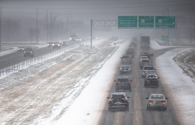 Traffic flows north on a patchy I-55 near Exit 96 during snow showers on Christmas Eve. [Justin L. Fowler/The State Journal-Register]