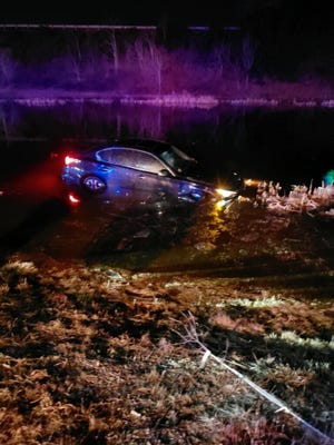 A car slid into the water near the Union Street rotary in Braintree overnight. Photo from Braintree Fire Department.