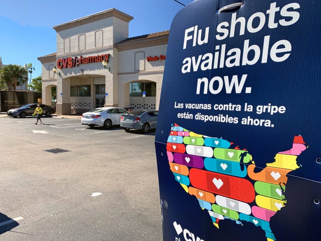 A sign advertises flu shots outside a CVS pharmacy in Lake Worth Thursday, January 10, 2019. [LANNIS WATERS/palmbeachpost.com]