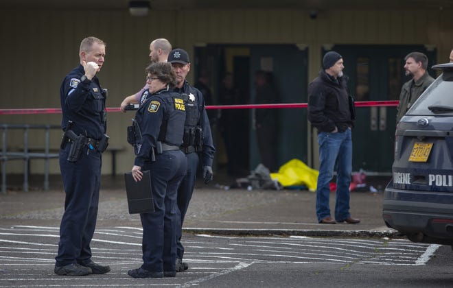 Eugene Police secure the scene of an officer involved shooting at the front entrance to Cascade Middle School in Eugene. [Chris Pietsch/The Register-Guard] - registerguard.com