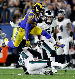 Running back Todd Gurley (30) leads the high-flying Los Angeles Rams' offense against the Dallas Cowboys in an NFC divisional playoff game Saturday in Los Angeles. [AP Photo/Marcio Jose Sanchez]