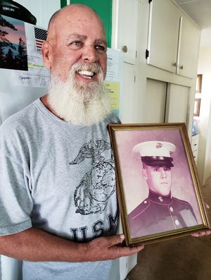 In this November 2018 image, which was taken one month before his death resulting from a brain tumor, retired Staff Sgt. Ray Adams shows off his Marine boot camp portrait. [KEITH OLIVER/CORRESPONDENT]