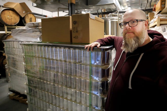 Patrick Rowan of Woodland Farms Brewery in Kittery stands with some of the nearly $20,000 worth of new beer that he can't ship until the federal government shutdown ends. The holdup means new beer can't be made, which may result in Rowan having to lay off employees.
[Ioanna Raptis/Seacoastonline]