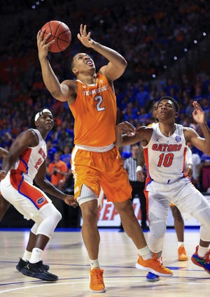 Tennessee forward Grant Williams (2) shoots next to Florida guard Noah Locke (10) during Saturday's game in Gainesville. [AP Photo/Matt Stamey]