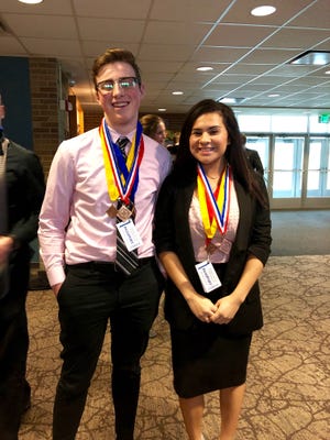 Hudsonville High School senior Austin Morton, left, and Zeeland West High School senior Monique Zuniga were among 18 Careerline Tech students to compete in the Distributive Education Club of America competition on Jan. 8 at Ferris State University. Fourteen of the 18 have advanced to the state competition in March. [Contributed]