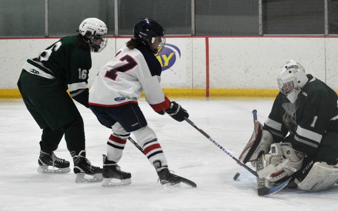 STA/Winnacunnet's Lauren Roughsedge, center, is stopped by Kingswood goalieIsabella Savage during action Saturday in Dover. To the left is Kingswood's Katherine Lessard. [Mike Whaley/Fosters.com]