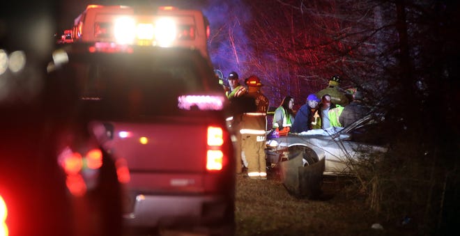 Emergency personnel work on the scene of a fatal wreck on Rube Spangler Road on Friday. [Brittany Randolph/The Star]