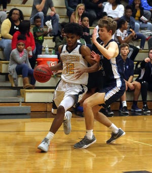 Kings Mountain’s Zeke Littlejohn dribbles around Gaston Day’s John Crump during the Mountaineer Classic championship game at Kings Mountain High School last month. [Brittany Randolph/The Star]