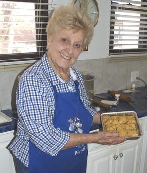 Penny Zavichas with a batch of baklava made by she and her sister, Connie, for their Sweet Greek bakery business, which sells its products at fairs and markets throughout the area. [View photo/Anthony Sandstrom]