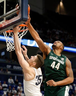 Michigan State's Nick Ward, right, blocks a shot by Penn State's Trent Butrick during the second half Sunday. [Chris Knight / The Associated Press]