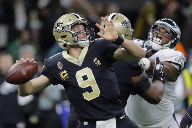 New Orleans Saints quarterback Drew Brees (9) throws an interception on the first play from scrimmage in the first half of an NFL divisional playoff football game against the Philadelphia Eagles, in New Orleans, Sunday. [Gerald Herbert/AP Photo]