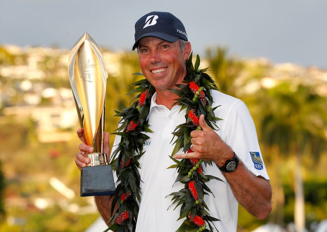 Matt Kuchar holds the champions trophy after the final round of the Sony Open PGA Tour golf event, Sunday, Jan. 13, 2019, at Waialae Country Club in Honolulu. (AP Photo/Matt York)