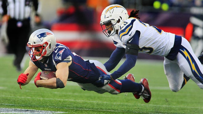 Julian Edelman stretches for a first down with a Charger on his back. 

The Patriots beat the Chargers to head to the AFC Championship 41-28 on Sunday, Jan. 13, 2019 Greg Derr/ The Patriot Ledger
