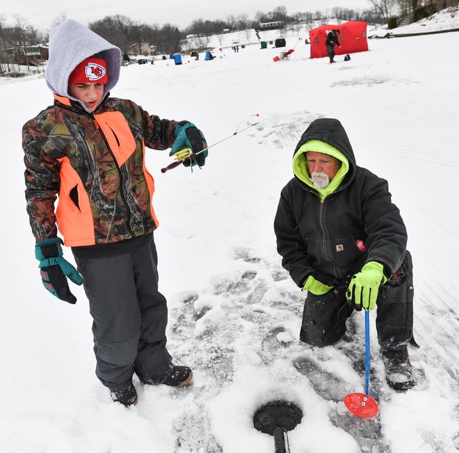 JOURNAL STAR FILE PHOTO Participants of all ages gathered on Lake Camelot for its ice fishing tournament in 2018.