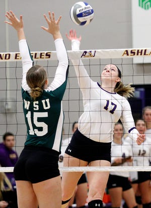 Alli Cudworth (right) gets a shot past Wayne State University's Emily Norscia while playing for Ashland University during the 2016 season. Cudworth is now playing volleyball professionally for Olympiada Neapolis.
