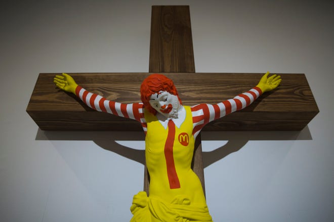 An artwork called "McJesus," which was sculpted by Finnish artist Jani Leinonen and depicts a crucified Ronald McDonald, is seen on display as part of the Haifa museum's "Sacred Goods" exhibit, in Haifa, Israel, Monday, Jan. 14, 2019. Hundreds of Christians calling for the sculpture's removal protested at the museum last week. (AP Photo/Oded Balilty)