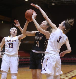 Stow's Lilee Carlson (21) takes a shot while being guarded by Jackson's Emma Dretke (13) and Rachel Stran (3) during the first quarter of their game at the Civic Center in Canton on Tuesday, Jan. 15, 2019. (CantonRep.com / Scott Heckel)
