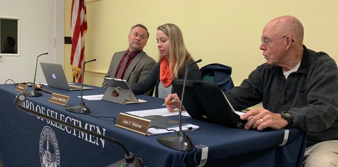 Board of Selectmen Chair Peter Bogren (left) converses with Selectmen John Malone (right) on appointing Selectmen Julia Pingitore (middle) to the Board of Health. The health board seat was left vacant after a long time member resigned in November 2018. [RACHEL ETTLINGER PHOTO]