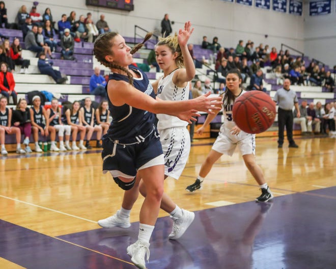 York junior Nina Howe reaches to save the ball as Marshwood's Grace Verrill defends during Saturday's Class A South girls basketball game at Marshwood. [Matt Parker photo/Seacoastonline]