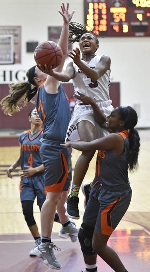 Braden River High's O'Mariah Gordon is fouled as she drives to the basket against Sarasota on Tuesday at Braden River in East Bradenton. Gordon scored 31 points in the Pirates' 72-49 win. [Herald-Tribune staff photo / Thomas Bender]