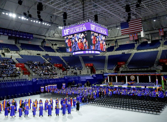 Students make their way to their seats at the start of the University of Florida doctoral commencement ceremony on Dec. 14, 2018. Students enrolled in UF Online learn from the same faculty and earn the same degree as those on campus, which contributes to the top-five national ranking the bachelor's degree program received from U.S. News & World Report on Tuesday, according to the program's director. [Gainesville Sun file photo]