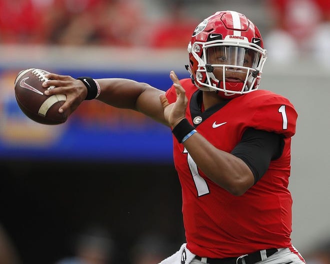 In this Sept. 15, 2018, file photo, Georgia quarterback Justin Fields (1) throws a pass in the first half of an NCAA college football game against Middle Tennessee, in Athens, Ga. Fields has transferred to Ohio State, and he awaits an NCAA ruling on whether he will be eligible to play football this fall. [John Bazemore/The Associated Press]