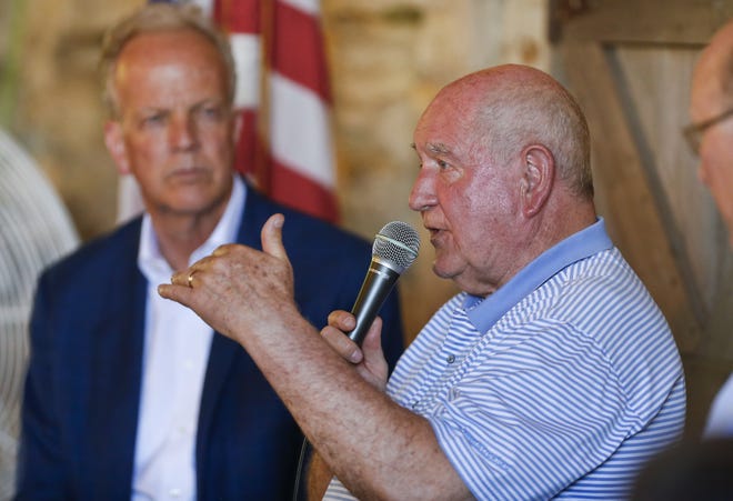 U.S. Secretary of Agriculture Sonny Perdue, right, answers a question from the crowd as he, along with U.S. Senators Jerry Moran, left, and Pat Roberts discuss the state of Kansas' agriculture with local farmers Wednesday afternoon at River Creek Farms outside of Manhattan. [Chris Neal/The Capital-Journal]