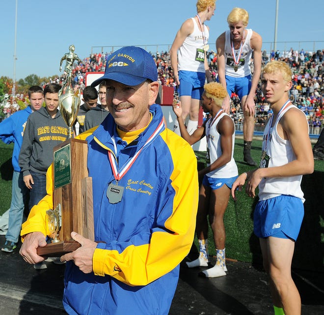 East Canton coach Lee Sternberg walks toward fans with the state championship trophy following the Pac Men's OHSAA Division III win at National Trail Raceway, Nov. 4, 2017. (CantonRep.com / Ray Stewart)