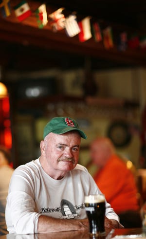 Tommy Leonard sits for a photo at the Quarterdeck Restaurant in Falmouth in 2007. Leonard, who founded the Falmouth Road Race, died Wednesday night at the age of 85. Bill Higgins, former Cape Cod Times sports editor, says Leonard should be remembered as the driving force behind the race and for so much more. [Cape Cod Times file]