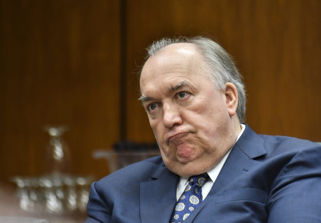 FILE - In this Feb. 16, 2018 file photo, Michigan State University interim President John Engler listens as he runs his first Michigan State University Board of Trustees meeting on campus in East Lansing, Mich. Engler will resign as interim president of Michigan State University amid public backlash over his comments about women and girls sexually assaulted by now-imprisoned campus sports doctor Larry Nassar, a member of the school's Board of Trustees said Wednesday, Jan. 16, 2019. (Matthew Dae Smith/Lansing State Journal via AP, File)