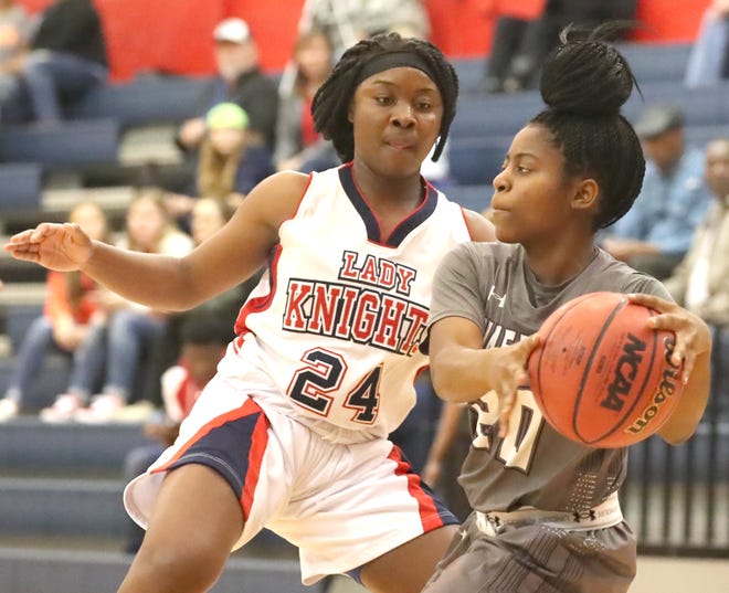 Gainesville's Jayden Williams (20) looks for a way to the basket as she is defended by Vanguard's Nasia Powell (24) during Vanguard's 59-37 win over Gainesville at Vanguard High School in Ocala Thursday. [Bruce Ackerman/Staff photographer]